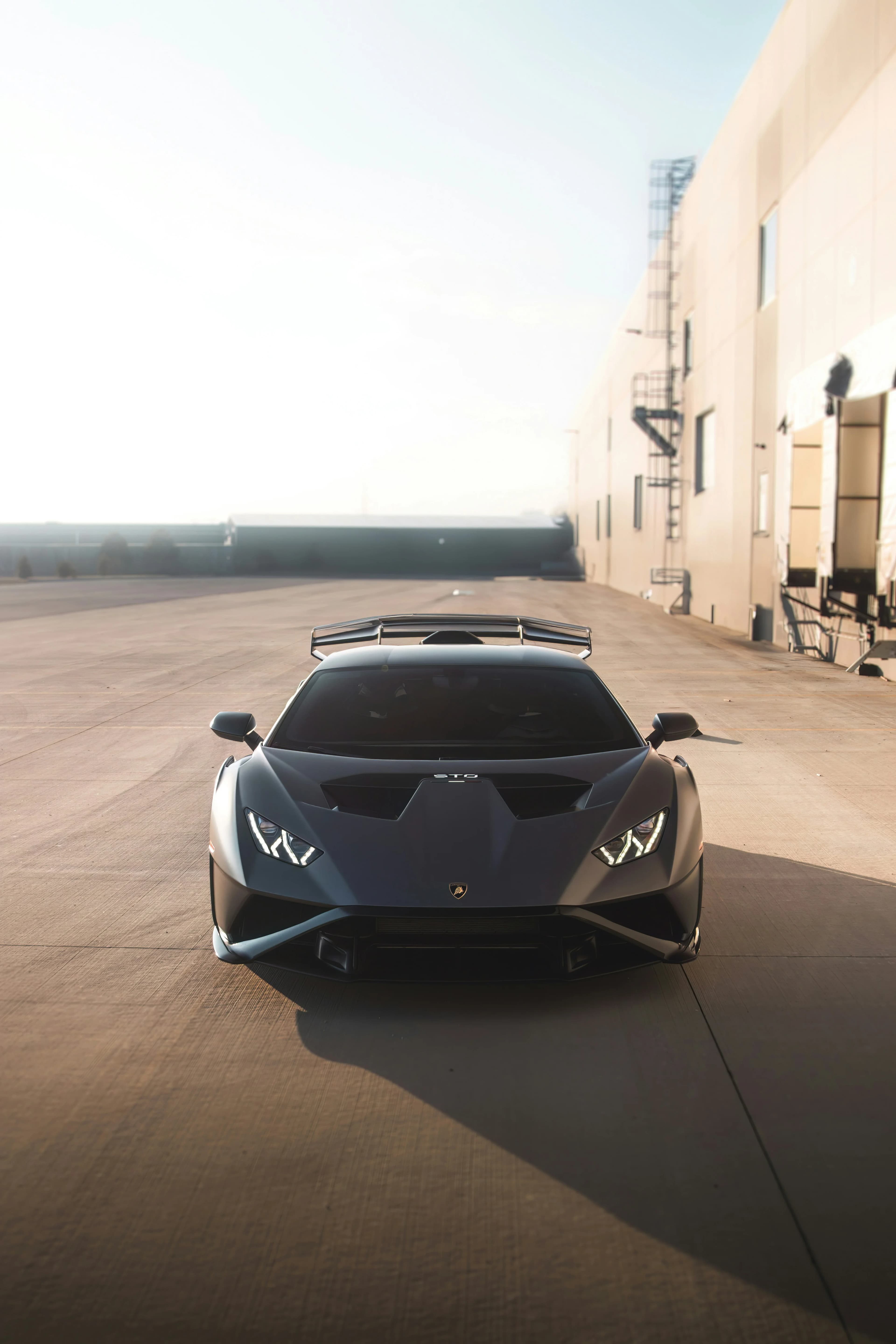 Grey Lamborghini Huracán STO front view at sunset